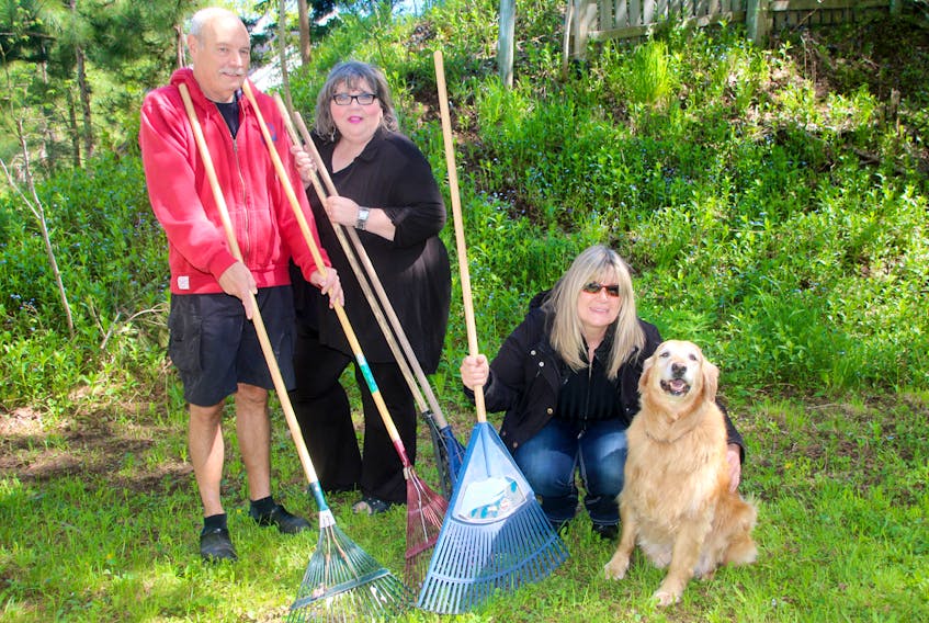 Members of the East End Community Association, from left, Bruce Purchase, Cathy Hinton and Deb Pryor, with Nishka, are encouraging people to perform random acts of kindness for neighbours. Raking leaves, walking dogs and pushing a composter to the curb are a few suggestions.
