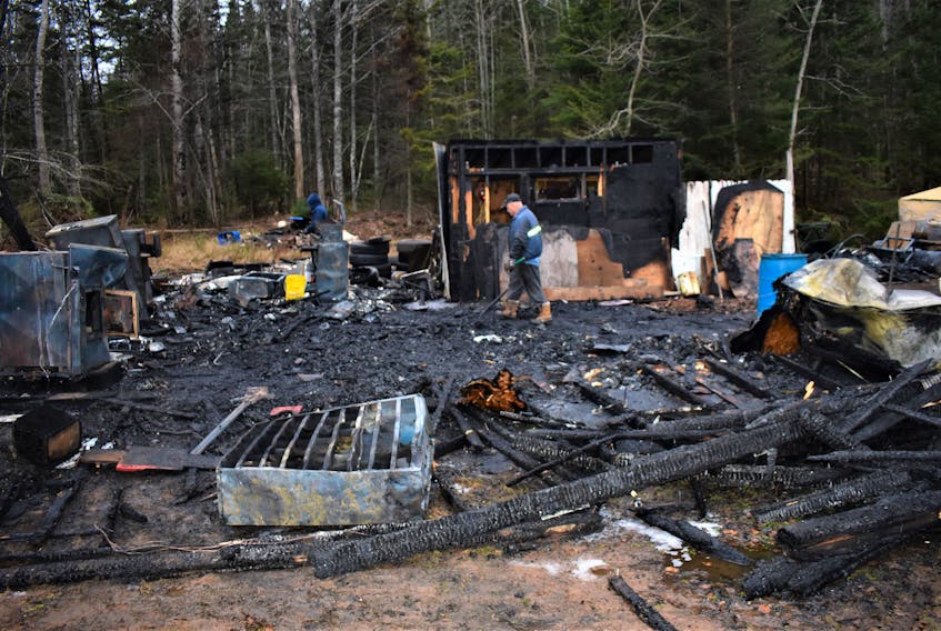Paul Ehler checks out the burnt remains of his garage, as well as the destroyed items that were housed in the structure. Brookfield Fire and Emergency Services responded to the fire, on Carter Road, around noon time.