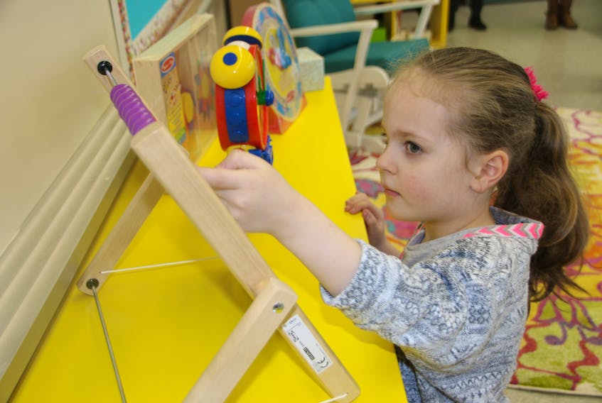 Madelyn Miller checks out some of the toys in the new Colchester Christian Academy K4-K5 classroom. The school has moved into the former East Court Road Elementary School, and classes begin there after March break.