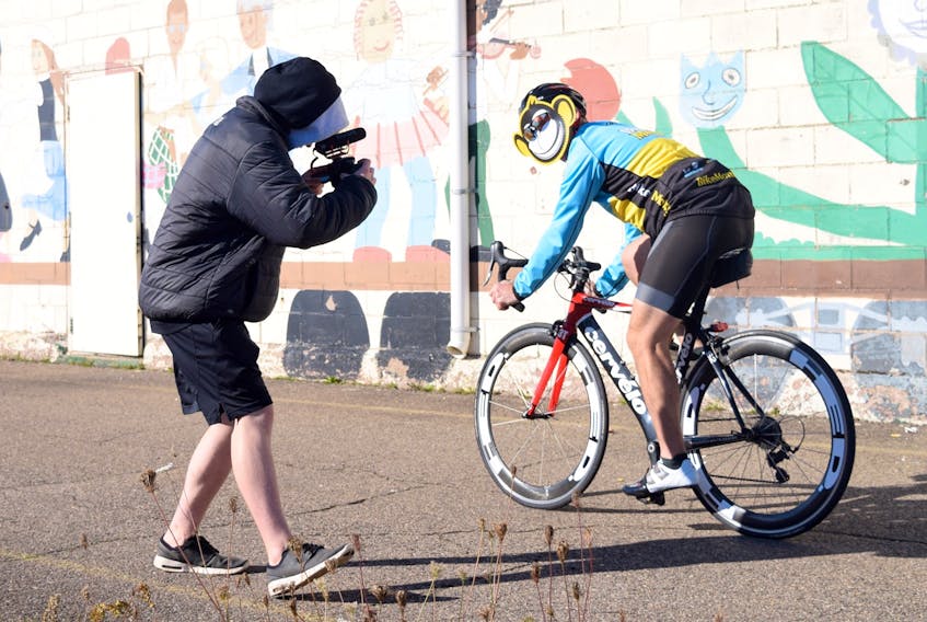 Ettnie Webster, student videographer for the Hubtown Ad Challenge,  captures shots of bike riders for the Bike Monkey commercial. Each rider wore a mask of Bike Monkey’s logo.
CODY MCEACHERN - TRURO DAILY NEWS