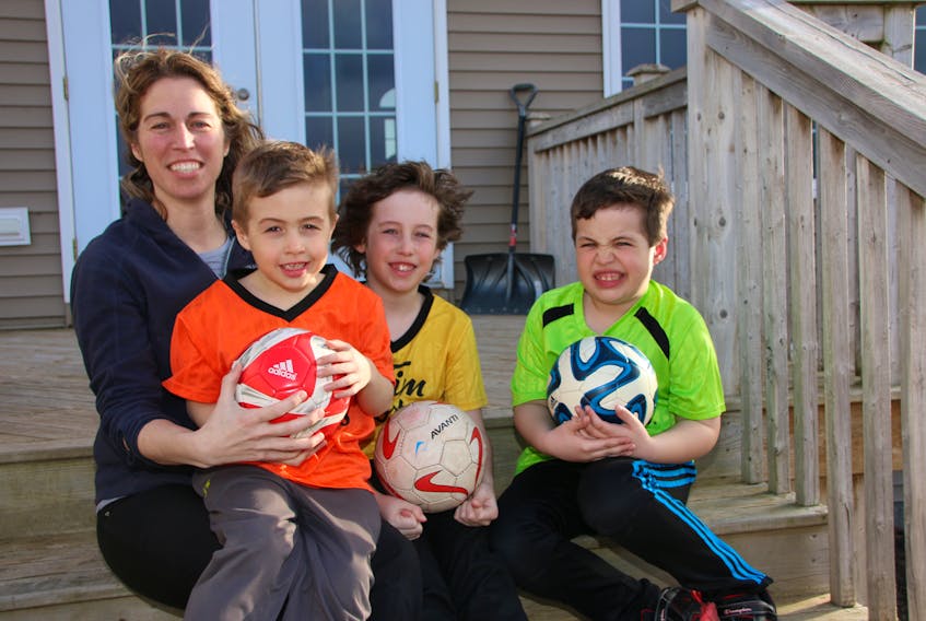 As a former soccer player and now a coach, Jennifer McKay has a lot of tips to share with her sons, from left, Coen, Ty and Jay Shreve.