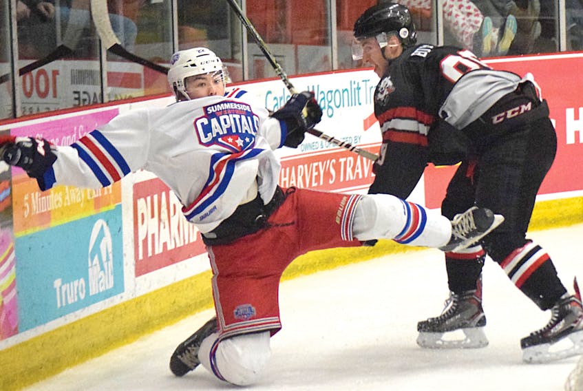 Jordan Spence of the Summerside Western Capitals goes flying after a check from Dylan Burton of the Bearcats during MHL action Friday in Truro.