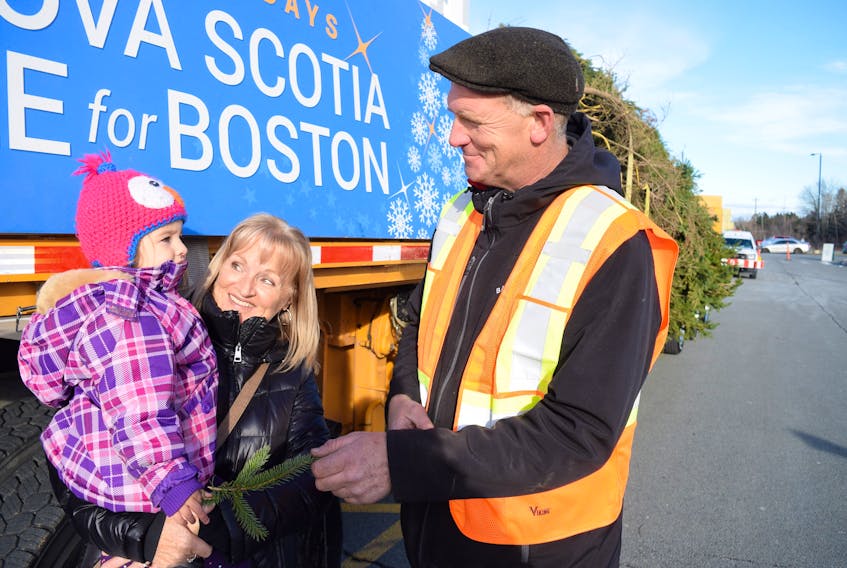 Dave MacFarlane has driven the Christmas tree from Nova Scotia to Boston for six straight years. He drove the flatbed truck carrying the tree to Truro’s Rath-Eastlink Community Centre on Nov. 15, where local families and schoolchildren came to check it out. From left, Lynn Chase and her granddaughter Nora Chase and Dave MacFarlane.
