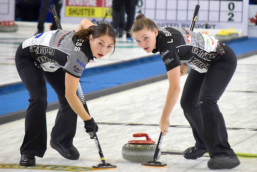 Karlee Burgess, left, and Lindsey Burgess sweep during opening-draw action on Tuesday at the Pinty's Grand Slam of Curling Masters at the Rath Eastlink Community Centre. The Colchester County duo are members of Team Kaitlyn Jones, which defeated Silvana Tirinzoni of Switzerland 7-4.