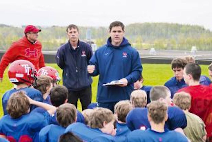 ['Despite losing several key players to graduation, head coach Scott O’Neal, shown above speaking to participants in a previous minor and high school spring training camp, will look to extend his team’s 19-game winning streak.']