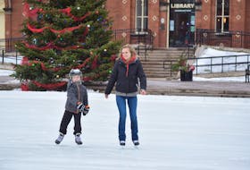 Bentley Weatherbee, left, and his mom Jessica Arsenault enjoyed a festive skate in front of the Christmas tree at Civic Square.