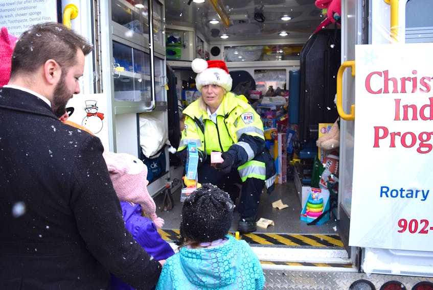 Paramedic Kate Messer had her hands full receiving toy donations from the Truro public despite Saturday’s snowy weather. Here, she took toys from Andrew Rahberg and his kids.