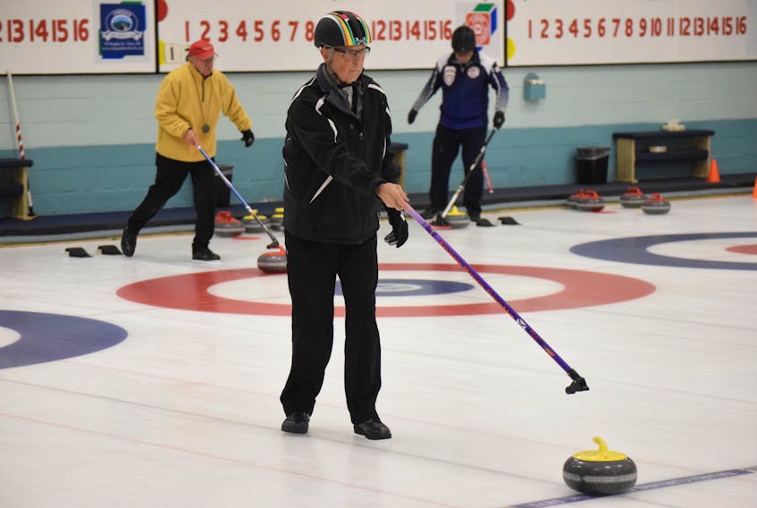 Stick curling requires some intense concentration, as Chuck Dyke learned. FRAM DINSHAW/COLCHESTER WEEKLY NEWS
