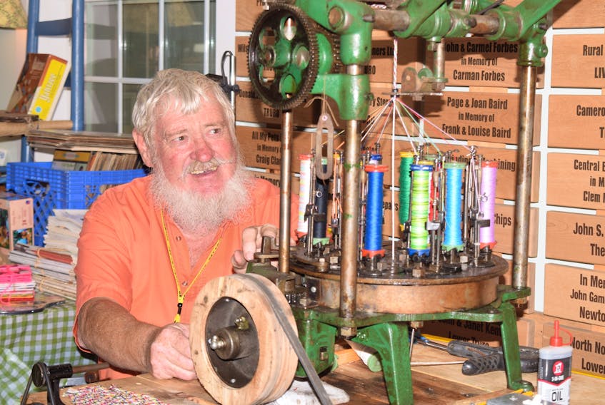 Allan Baird uses a maypole braider device to weave shoelaces and bracelets for sale. FRAM DINSHAW/TRURO NEWS