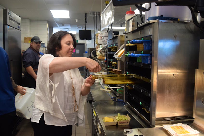 Stephanie Jones often helps out on the kitchen floor in her restaurants, prepping burgers and fries for customers.