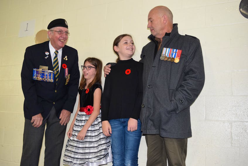 Children at North River Elementary School enjoyed spending time with veterans and Royal Canadian Legion members. From left: Legion representative Murray Dawson, Emily Pratt, Lily-Beth Fisher and her grandfather Ken Copeland.