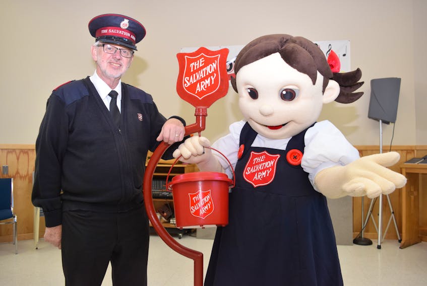 Major Bruce Jenkins, at left, of the Truro Salvation Army office mascot Sally Ann are encouraging area residents to consider volunteering for this year's Christmas Kettle Campaign. The office is looking for at least 100 volunteers to fill the required posts.