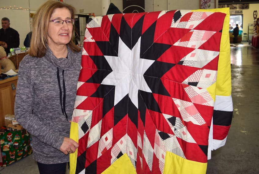 Terry Hearn, executive director of the United Way - Colchester County, displayed a star blanket weaved by prior inmates at the Nova Institute for Women at the Truro Farmers Market on Jan. 18. This quilt was made in support of the United Way's charity work in the Truro region. Star blankets like this one are presented to recipients as a sacred gift, to mark major life milestones in First Nations culture.