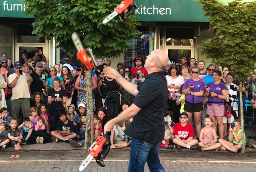Ian Stewart handles potentially lethal chainsaws rather smoothly - and safely - during his juggling act.