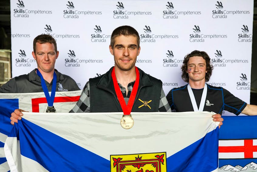 Pomquet’s Tanner Doiron holds up a Nova Scotia flag while wearing the gold medal he earned during the 2019 Skills Canada National Competition (SCNC), which was held in Halifax May 28 and 29.