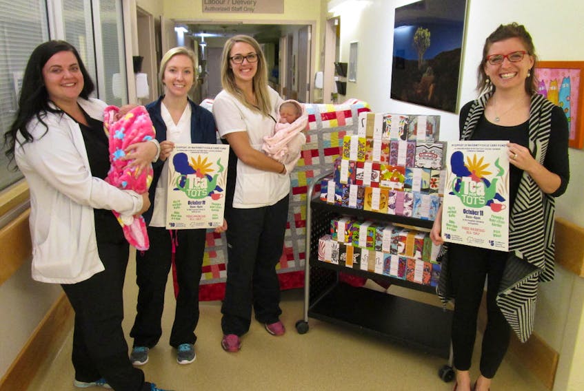 Nurses (from left) Alyson Kitchen, Erin Dowe and Danielle Walker and Dr. Beth Ellen Brown show off two beautiful newborn girls alongside a sampling of the mugs and handmade quilt that will be at Tea for Tots, Thursday, Oct. 11, from 8 a.m. to 6 p.m. at the Cumberland Regional Health Care Centre.