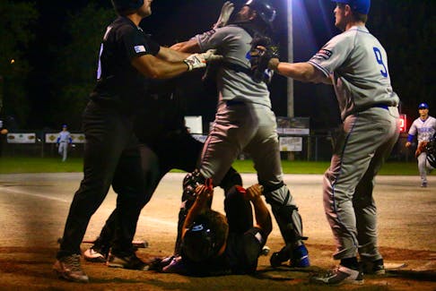 Newfoundland Galway Hitmen runner collides with the B.C pitcher, who was covering home plate.