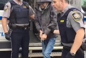 Serial impaired driver Terry Lee Naugle is escorted into the Dartmouth courthouse Wednesday to face his latest charges.