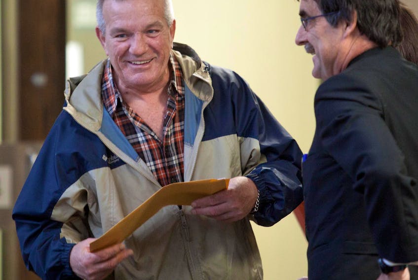 Terry Marriott Sr., the patriarch of a well-known Halifax crime family, chats with lawyer Chris Manning at the Halifax Law Courts in 2011. Marriott died Tuesday at the age of 70.