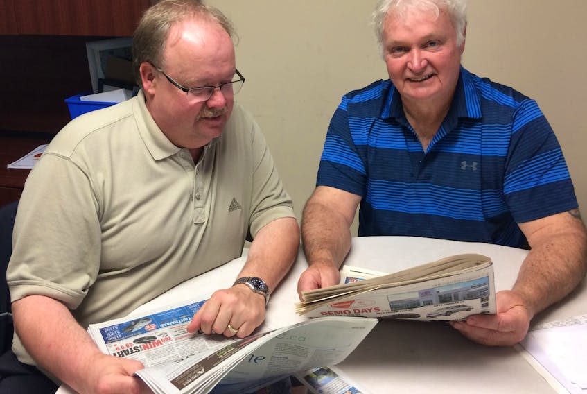 Amherst News managing editor Darrell Cole (left) helps Dale Fawthrop research the Amherst News and Citizen-Record newspapers in preparation for next week’s This Is When on CFTA Tantramar Radio. Fawthrop is dedicating next week’s shows to the history of both newspapers.