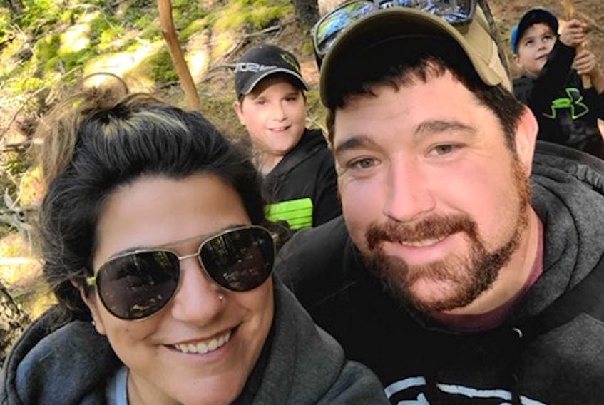 Tim Amero, a third-generation forest worker and owner of Cut Rite Logging in New Edinburgh, poses with his girlfriend, Denise Tardif, and her two boys, Marcien and Miguel.