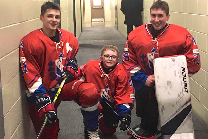Sackville Minor Hockey player Lane Pierce was welcomed as the Titans ‘7th player’ last month during one of the team’s home games. Also pictured are Titans' Jesse Estabrooks, left, and Noah Boyd.