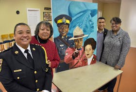Leanne (MacDonald) Sample, Cathy Thomas, Sgt. Craig Smith and Carmelita (Cromwell) Johnson stand next to a painting by Letitia Fraser that features images of Rose Fortune, Insp. Sherley Goodgie, Const. Carline‎ Fidele and Const. Shelley Peters during an event in Yarmouth County celebrating ‘Black Women Making a Difference in Canadian Law Enforcement.' TINA COMEAU PHOTO
