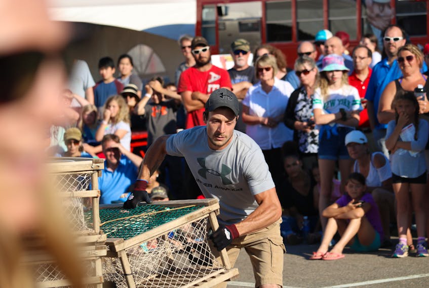 North Port lobster fisherman Lucas Murphy hauls a 95-pound lobster trap during the Journal Pioneer Lobster Trap Stacking Competition on Thursday evening.