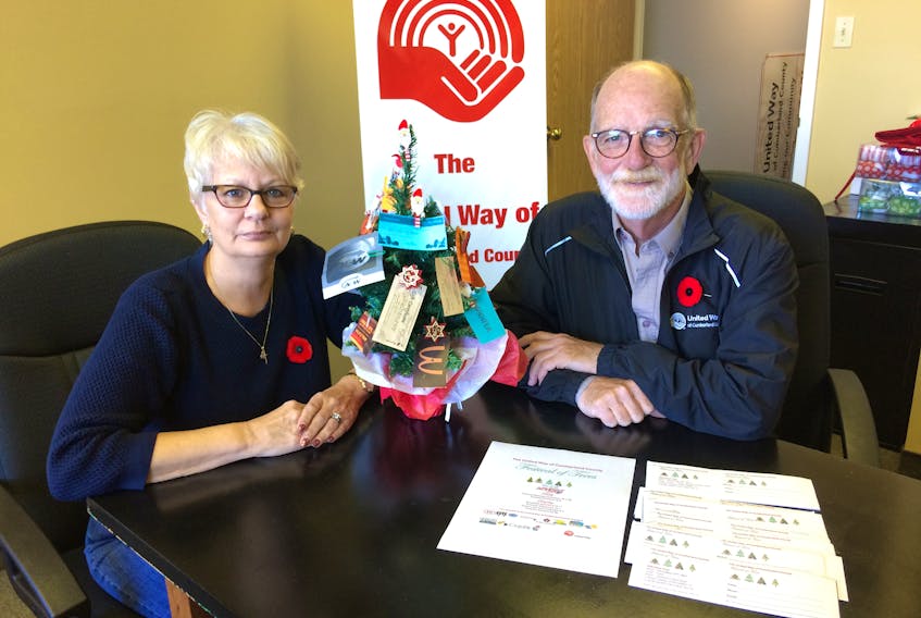 United Way executive director Cathy Skinner and chairman David March look over plans for the organization’s first Festival of Trees at the Amherst Centre Mall on Nov. 17 and 18.