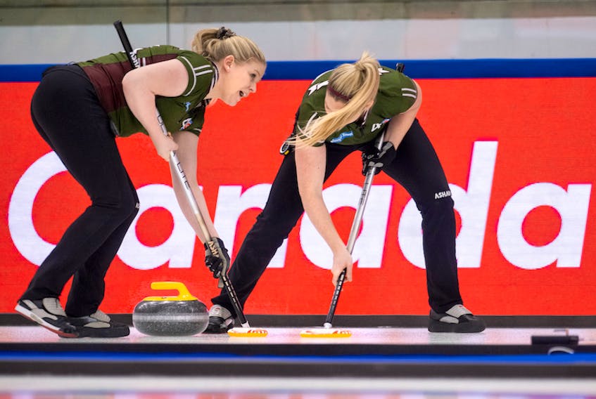 P.E.I. third Marie Christianson and second Meaghan Hughes sweep a rock at the 2021 Scotties Tournament of Hearts in Calgary. P.E.I., which completed round-robin play 4-4 (won-lost), will not advance to the championship pool.