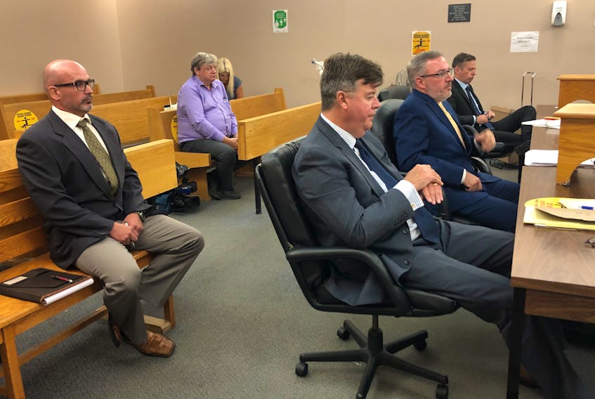 Elementary school principal Robin McGrath (left) awaits Provincial Court Judge David Orr's entrance to the courtroom at his trial in St. John’s Wednesday morning. Sitting in front of McGrath are (foreground to background) defence lawyers Tom Johnson and Ian Patey, and prosecutor Shawn Patten.