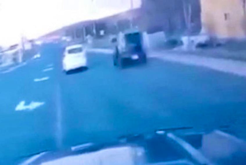 A screen shot of the video taken from a dash cam on May 11 shows a Kia Soul speeding by on Topsail Road moments before it was involved in a fatal collision at the intersection of Hamlyn Road. — CONTRIBUTED