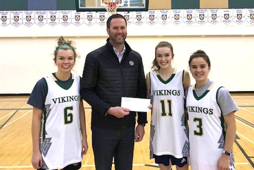 Tantramar Chevrolet general manager Johnathan MacMaster presents a sponsorship cheque to Vikings players (from left) Lauren Furlong, Olivia Scott and Keira Dyck.