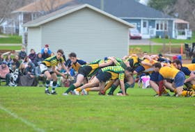 The host Three Oaks Axemen, striped shirts, and Westisle Wolverines battle in the opening game of the 22nd annual David Voye Memorial rugby tournament at Three Oaks Senior High School in Summerside on Thursday night.
