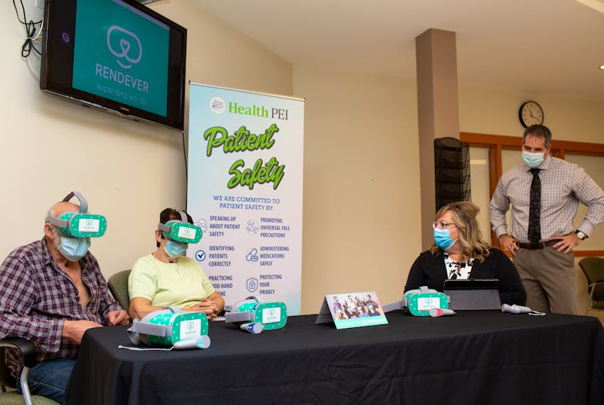 Paul Arsenault, left, board member of the Community Health Foundation in O'Leary and Eva Rogerson, board chairwoman, try Rendever virtual reality headsets with Pam Corrigan, activities director for Margaret Stewart Ellis Home and Paul Young, administrator for Community Hospitals West.