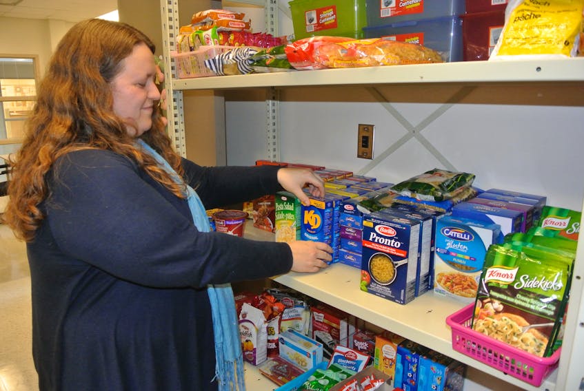 Amherst Regional High School resource teacher Jennifer Hines stocks the shelves in the ARHS Viking Pantry. The pantry has been a hit with students since it opened last fall and the organization has received a Building Vibrant Communities grant from Communities, Culture and Heritage.