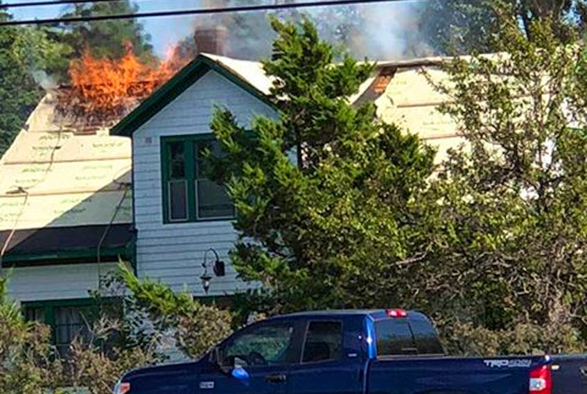Flames shoot out of the roof of the Green Gables Post Office in Cavendish. The picture was taken by Melissa Hickox, a staff member at the Cavendish Hotel.