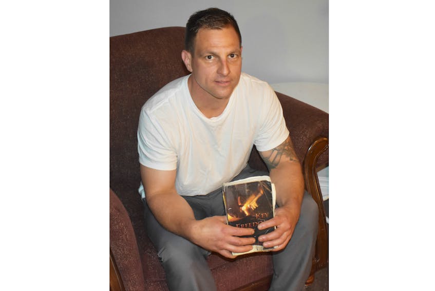 Anthony TIbbo holds the Bible that was given to him by a Salvation Army worker while he was in prison. What he read, he says, God used to change his life.