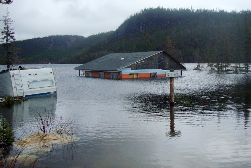 The rising water level at Bottomless Pond in the Goose Arm area is evident as a cabin and a trailer are submerged.