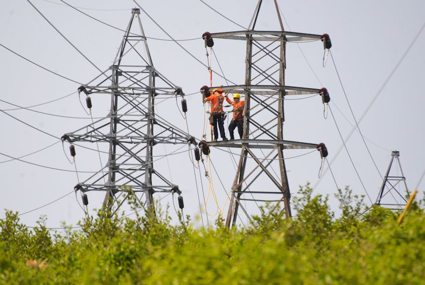 A Newfoundland Power crew goes about repairing a tower in the Massey Drive area Monday in the midst of a prolonged power outage that affected the Corner Brook and surrounding area.