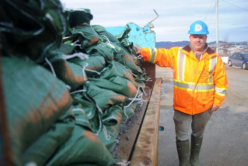 City of Corner Brook employee James Snow poses for a photo with some of many sandbags the city has prepared in case of any flooding issues with this weekend’s rainy weather.