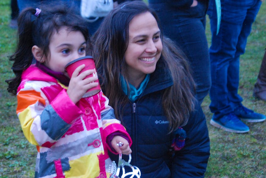 Nancy Buckle and her daughter Layla, who is enjoying a hot chocolate, were among the people who attended the Take Back the Night Rally held Friday night at Margaret Bowate Park.