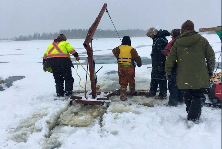 Workers start the task of lifting the intake off the bottom of Sandy Lake. - Photo courtesy Wayne Bennett/Twitter