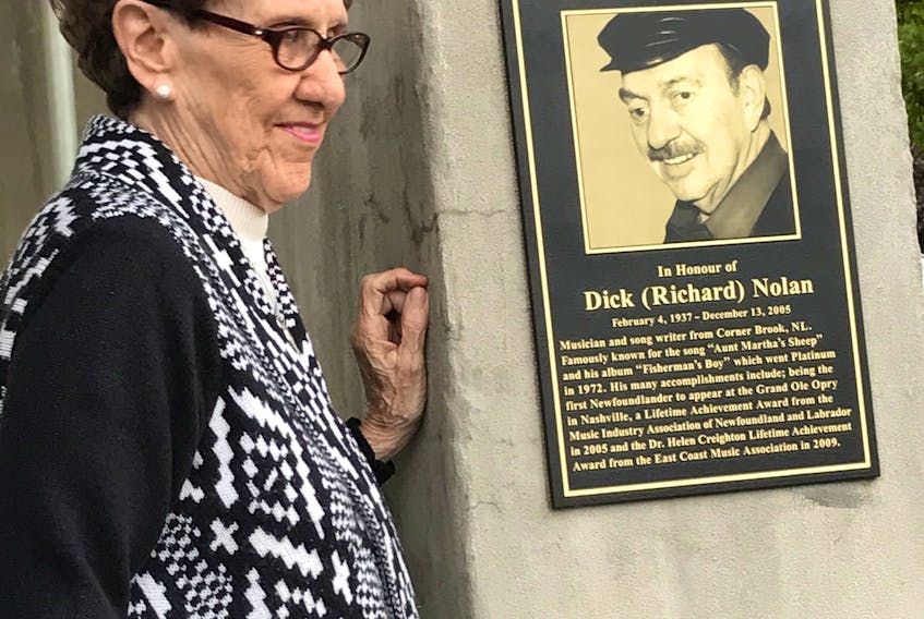 The stage at Margaret Bowater Park in Corner Brook was officially named The Dick Nolan Performance Stage during a ceremony on Thursday evening. Mr. Nolan, who died in 2005, was a musician and song writer from Corner Brook famously known for the song “Aunt Martha’s Sheep.” His sister, Priscilla Boutcher, is pictured next to the plaque that is now posted on the outside of the stage.  - City of Corner Brook photo