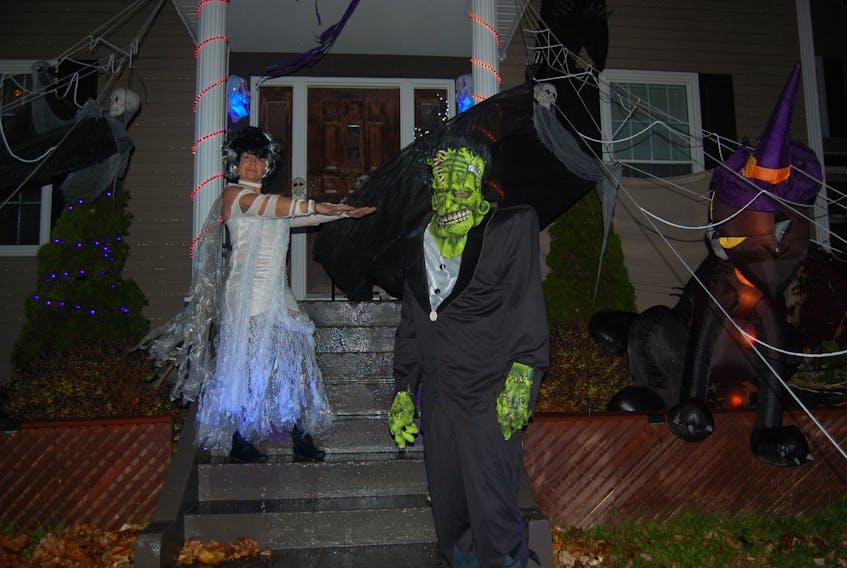 Susan and Sheldon Lane love the Halloween season. They are seen here in costume as “Bride of Frankenstein” and “Big Frankie” in front of their decorated home at 23 Hillview Avenue in Stephenville.