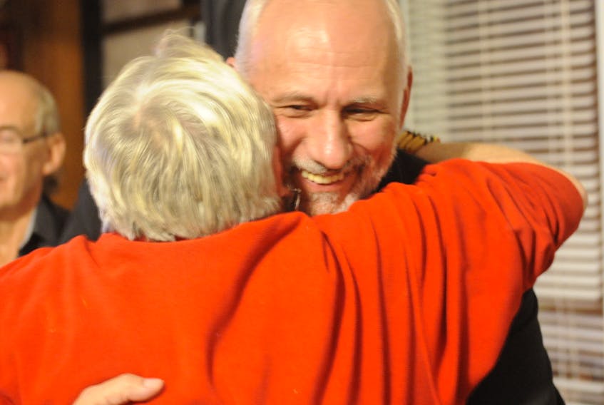 Brian Dicks gets a hug from supporter Lorraine Stone moments after being declared re-elected as Corner Brook ward councillor for the Qalipu Mi’kmaq First Nation Band Tuesday night.