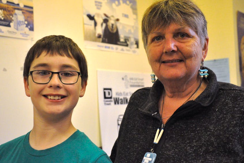 Patrick Ballett, a Grade 5 student at Our Lady of Mercy School, poses for a photo with Darlene Sexton, a Mi’kmaq knowledge sharer/keeper who will be volunteering her time for a project entitled “Elders and Youth Breaking the Silence on Mental Health.” Ballett’s drawing was selected as the logo for the project.