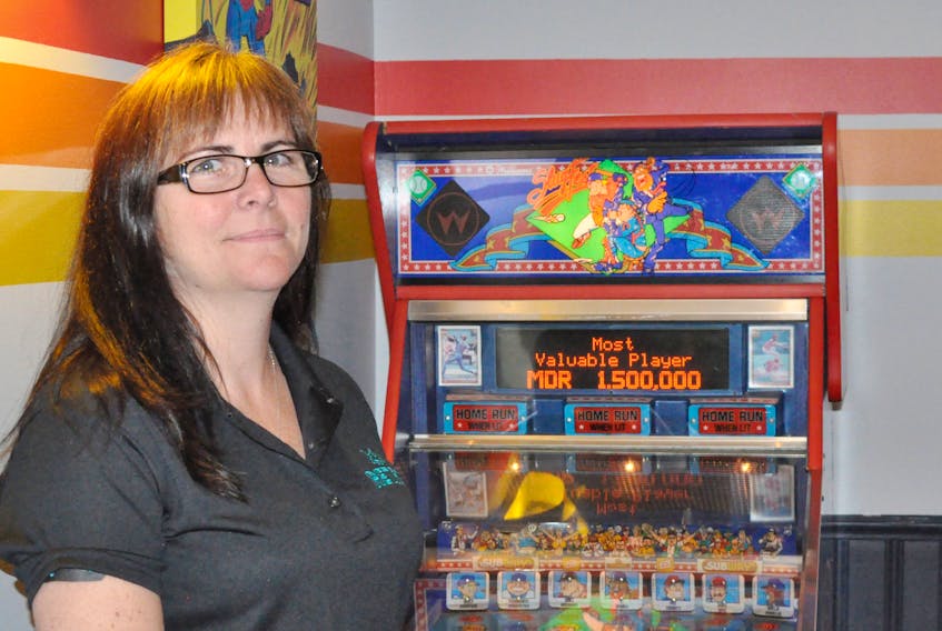 Connie Stevens poses by the Slugfest pinball machine at her new video arcade that she’s opening on West Street in Corner Brook.