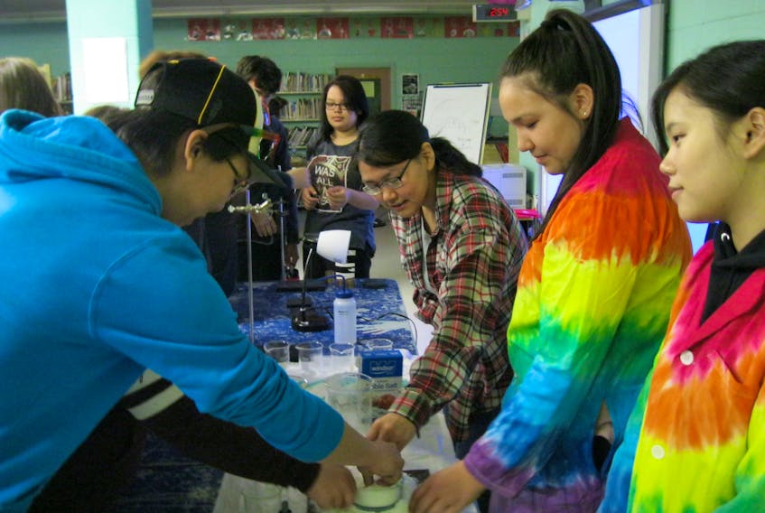 Chaim Andersen and her colleague, Yu-Ru Lee, right, watch students investigate water-absorbing compounds in diapers at Jens Haven Memorial School in Nain.