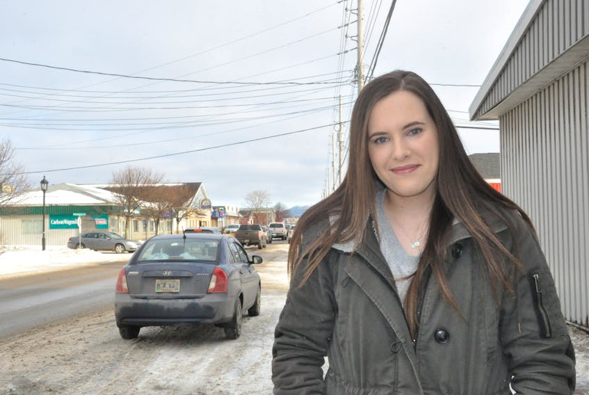 Stephenville businesswoman Ashley Pomeroy poses for a photo on Main Street in Stephenville. She is concerned about businesses in the town being targeted in a scam where someone impersonates a person from Google.